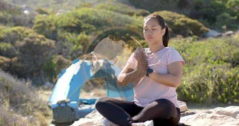 Woman Meditating by Campsite Expressing Mindfulness and Adventure