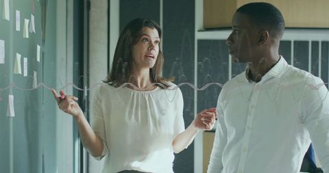 Business Professionals Collaborating on Strategy in Modern Office