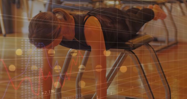 This image depicts a woman exercising at a gym, performing a push-up while balancing on an exercise bench. Overlaid graphs and data points highlight performance metrics and tracking. Useful for illustrating fitness progress, workout routines, performance monitoring, and healthy living.