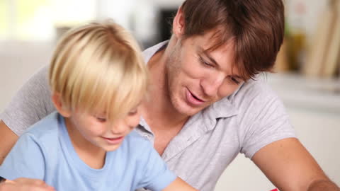Father and Son Bonding Over Coloring Activity at Home