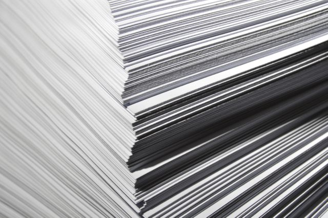Image shows a close-up of neatly stacked black and white papers, emphasizing the texture and alignment of the lines. The abstract pattern created by the paper's edges presents a minimalist geometric feel and can be used in office themes, art and design concepts, graphic design projects, or website backgrounds.
