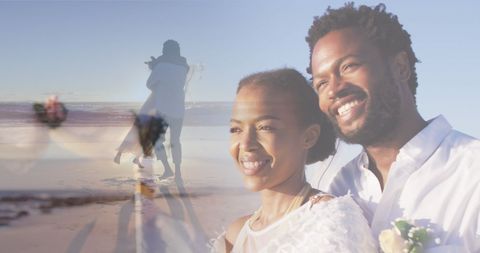 Romantic african american couple smiling on beach