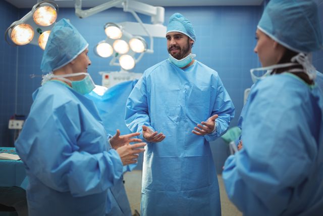 Team of surgeons having discussion in operation theater at hospital