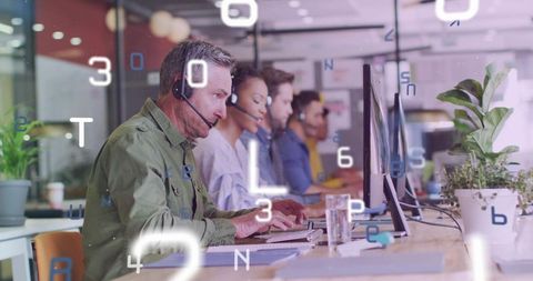 Call center agents providing remote support in modern open-plan office with headsets