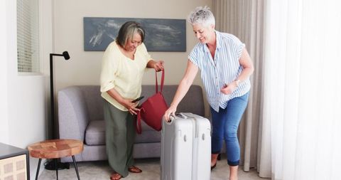 Happy Senior Lesbian Couple Packing for Vacation