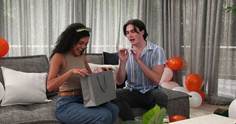Happy Couple Celebrating Birthday with Gifts in Living Room