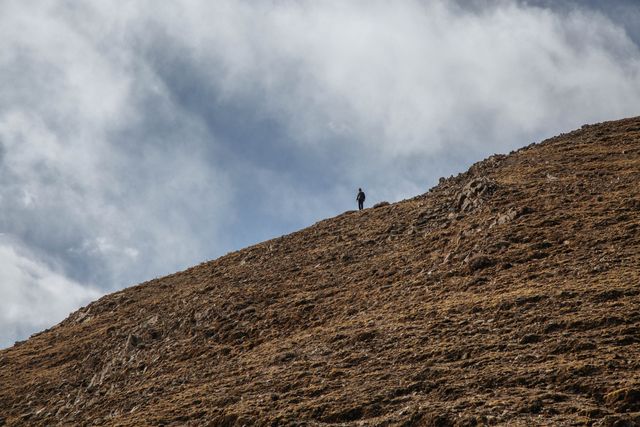 Solo Hiker on Mountain Ridge with Dramatic Sky - Download Free Stock Images Pikwizard.com