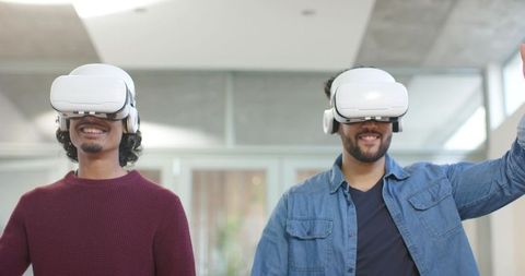 Coworkers Testing VR Headsets in Modern Office for Team Collaboration and Training