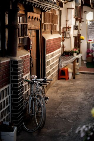 Vintage Korean Hanok Street with Bicycle and Flower Pots - Download Free Stock Images Pikwizard.com