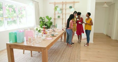 Women socializing during cozy home gathering celebration