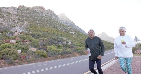 Active Senior Couple Exercising Outdoors in Scenic Mountain Area