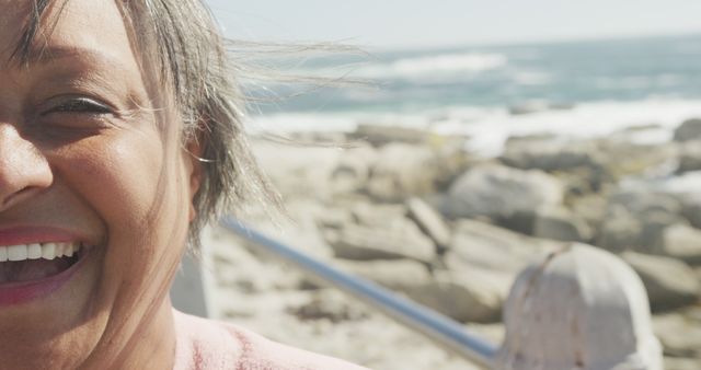 Smiling Elderly Woman by Ocean on Windy Day - Download Free Stock Images Pikwizard.com