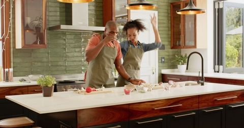 Couple Enjoying Cooking Together in Stylish Modern Kitchen