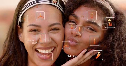 Closeup friends laughing and pressing cheeks together wearing headbands with hud icons