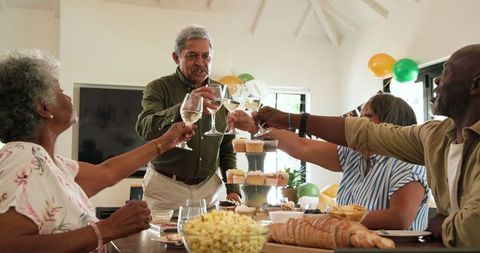 Senior Friends Celebrating with Toast in Bright Living Room
