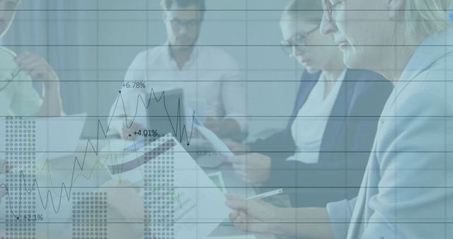 Business professionals analyzing data with graph overlay in boardroom