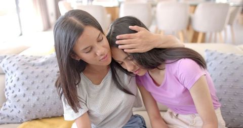 Teen Girl Consoling Friend on Couch in Supported Moment