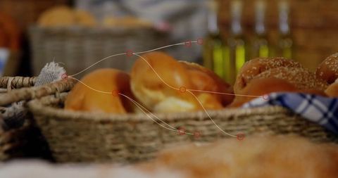 Artisan bread rolls in wicker baskets with oil bottles