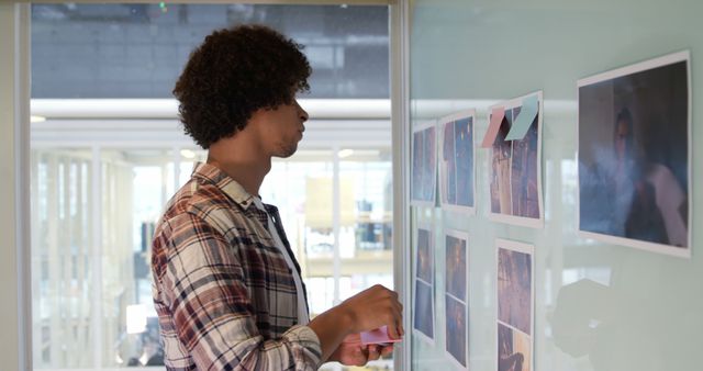 Young Professional Using Sticky Notes for Creative Collaboration in Office - Download Free Stock Images Pikwizard.com