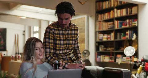 Couple Relaxing and Browsing Laptop at Home