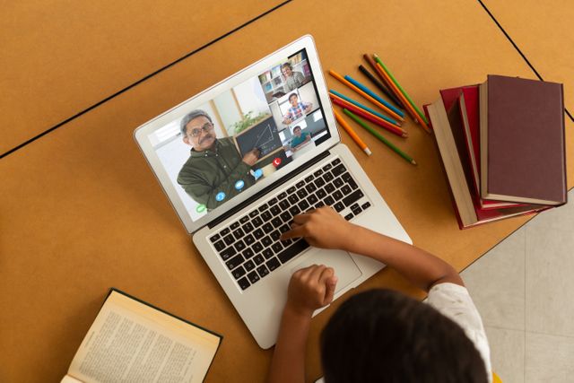 Biracial boy using laptop for video call, with diverse elementary school pupils on screen - Download Free Stock Photos Pikwizard.com