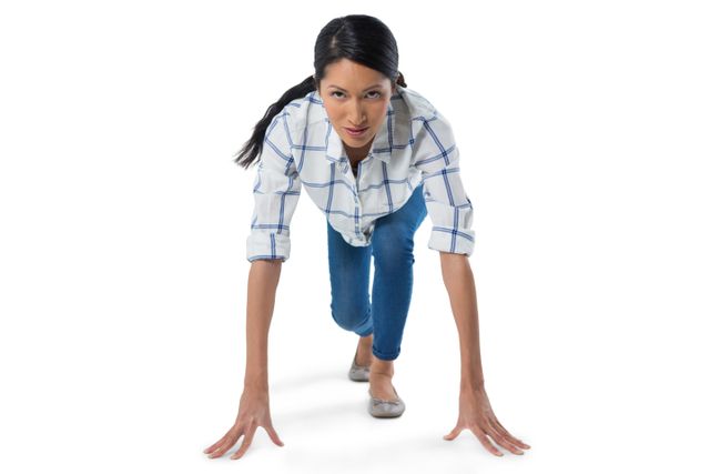 Woman in plaid shirt and jeans preparing to run, showing determination and focus. Ideal for use in fitness, sports, motivation, and health-related content. Can be used in advertisements, blogs, and articles promoting an active lifestyle and personal growth.