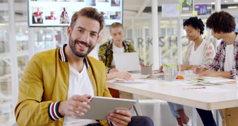 Creative Professional Using Tablet in Modern Office Environment