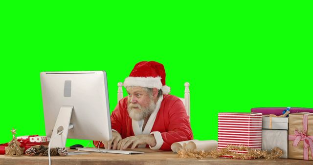 Santa Claus Using Computer with Green Screen Background in Christmas Setting - Download Free Stock Photos Pikwizard.com