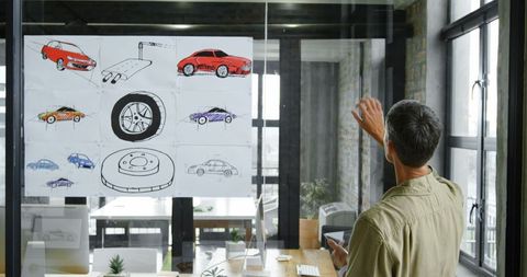 Engineer presenting car design ideas in modern office