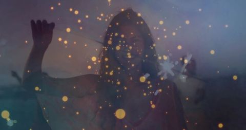 Smiling woman silhouette raising arm at dusk with golden bokeh sparks dreamy double exposure