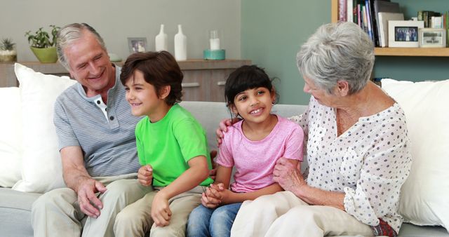 Happy Grandparents Sitting with Children on Sofa, Enjoying Time Together - Download Free Stock Images Pikwizard.com