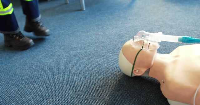 CPR Training Mannequin with Oxygen Mask on Office Floor - Download Free Stock Images Pikwizard.com