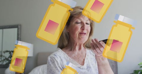 Senior woman using smartphone amidst medication icons
