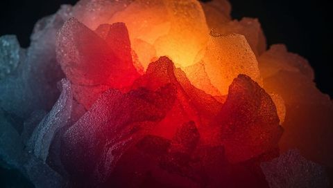 Glowing ice shards forming abstract crystal cluster with warm core and cyan rim