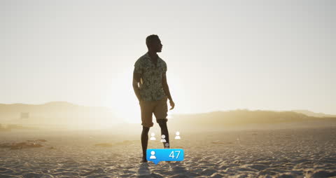 Man Walking on Beach at Sunset with Social Media Reactions