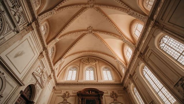 Baroque vaulted groin ceiling with ornate ribs and clerestory windows in cathedral interior