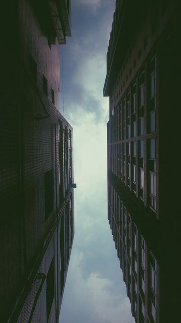 Dramatic View Between Tall Urban Buildings - Download Free Stock Photos Pikwizard.com
