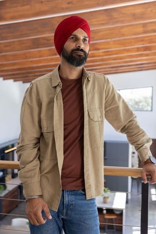 Modern Home Balcony View with Man in Casual Outfit Underlining Contemporary Lifestyle