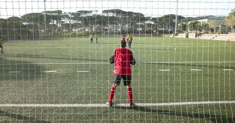 Confident Goalkeeper Focuses During Soccer Match on Field