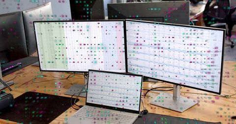 Multiscreen setup displaying spreadsheets on laptop and dual monitors for productivity