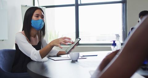 Woman Wearing Face Mask Using Tablet in Office Meeting - Download Free Stock Images Pikwizard.com