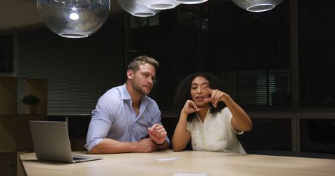 Diverse Team Collaborating on Late-night Office Project
