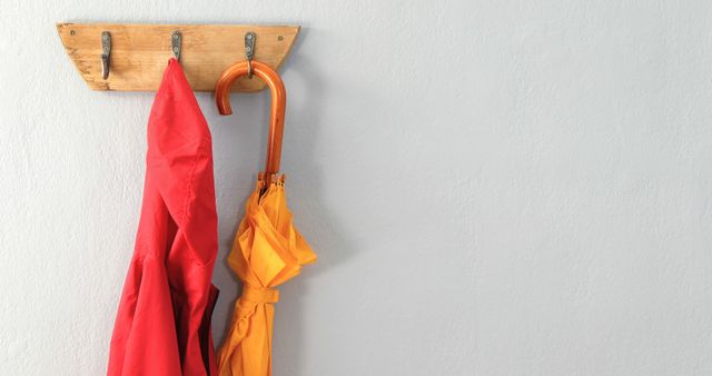 Red Jacket and Orange Umbrella Hanging on Rustic Wooden Hook - Download Free Stock Images Pikwizard.com