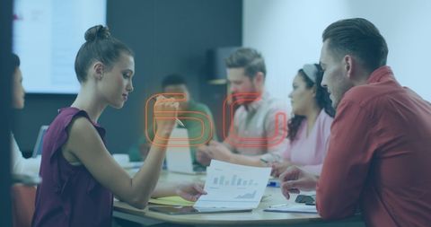 Team collaborating in modern office with media connections