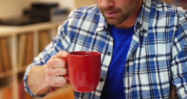 Man Drinking Coffee from Red Mug in Casual Setting - Download Free Stock Images Pikwizard.com