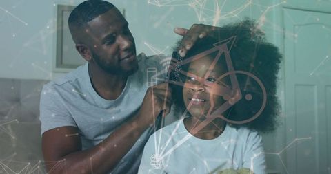 Black father parting and smoothing daughter's natural hair with comb, tender morning bond