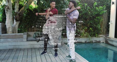 Two men stretching on pool deck wearing casual clothing with holographic globe overlay