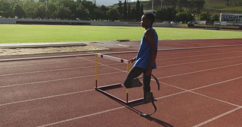 Inspirational Adaptive Athlete with Prosthetic Legs Training on Running Track - Download Free Stock Images Pikwizard.com