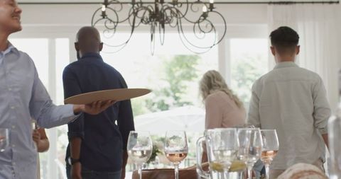 Guests socializing at elegant wedding reception with wines