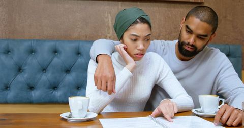 Serious Discussion of Young African American Couple in Cafe
